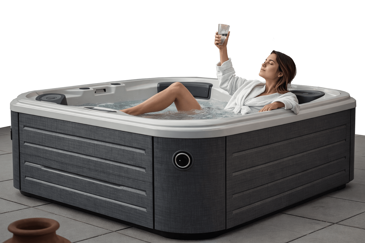 Woman in a white robe relaxing in an outdoor hot tub, raising a glass in celebration.