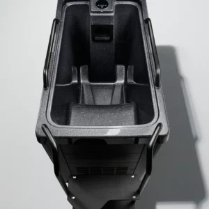 Top-down view of a black, textured industrial trolley with side handles and a recessed control panel at the front.